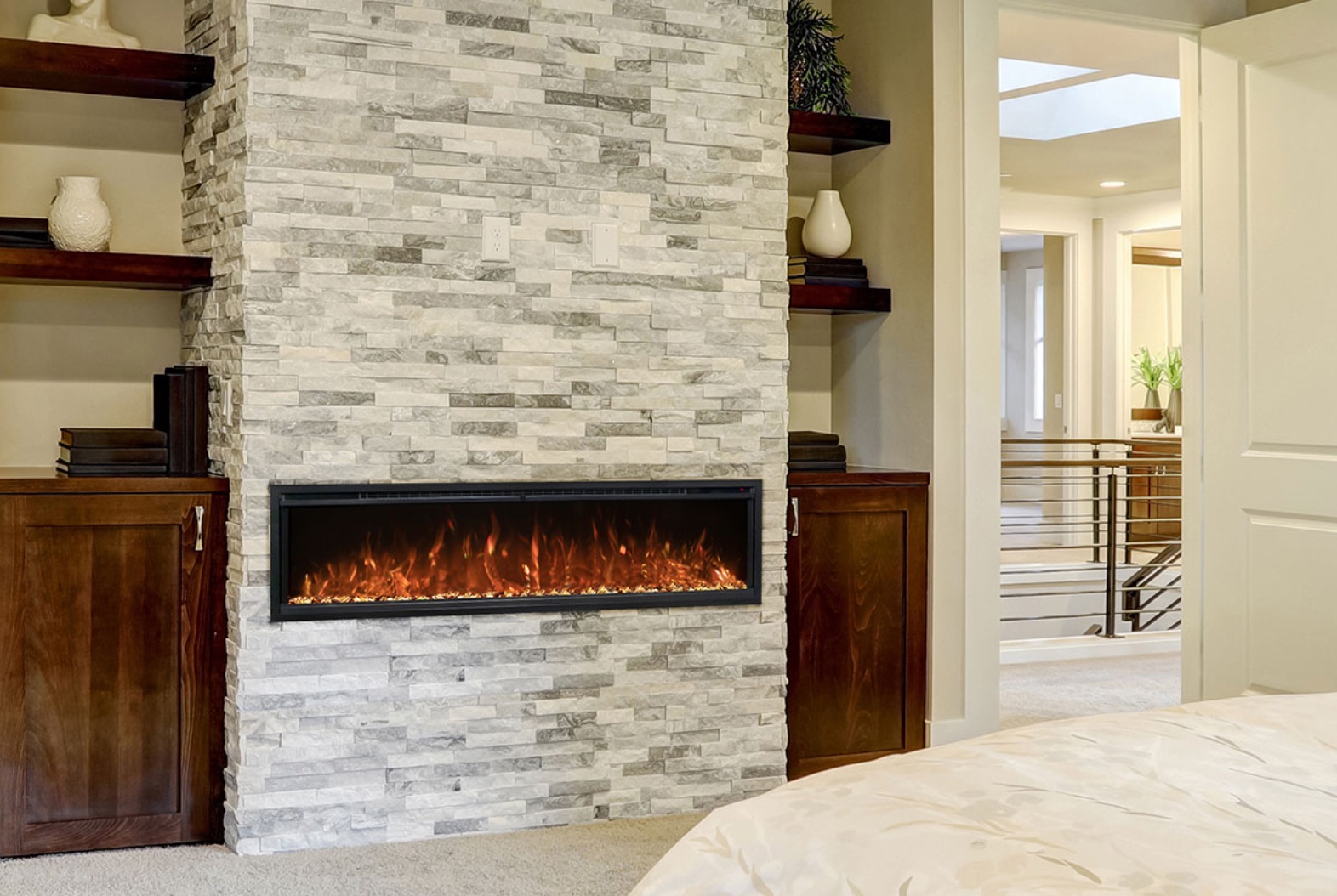 modern flames spectrum slimline electric fireplace recessed in white stacked stone in a bedroom