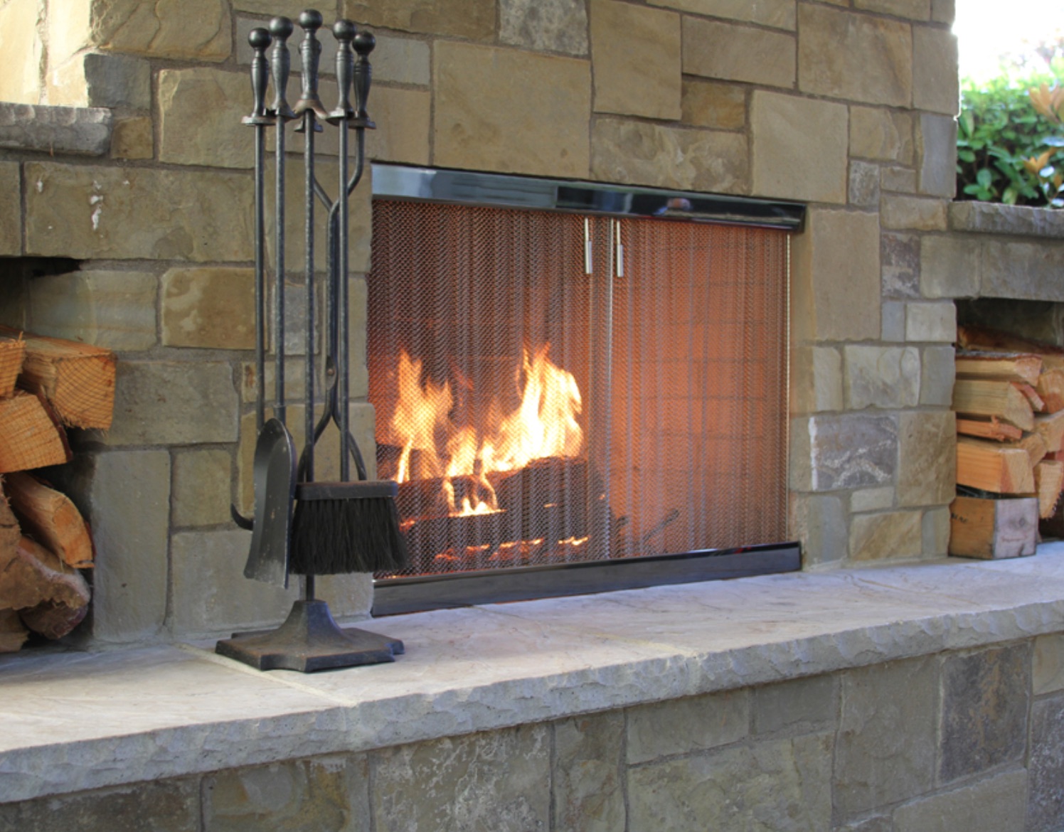 fireplace screen on stone outdoor fireplace
